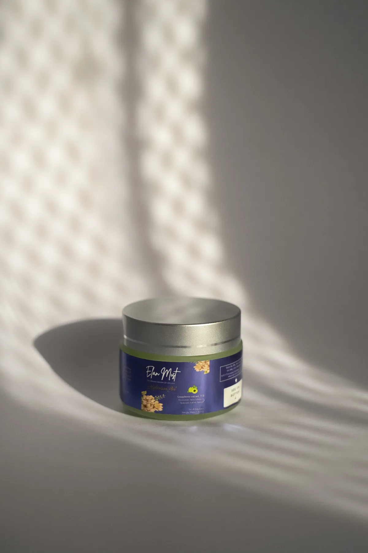 Elanmist HydroBoost Gel jar in soft window light and shadow
