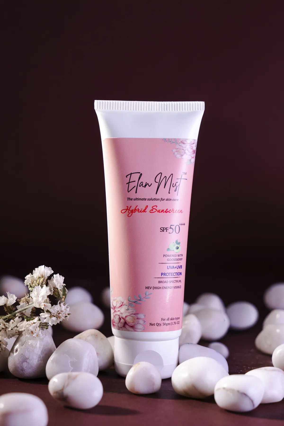 Elanmist Hybrid Sunscreen SPF 50 tube standing on white stones